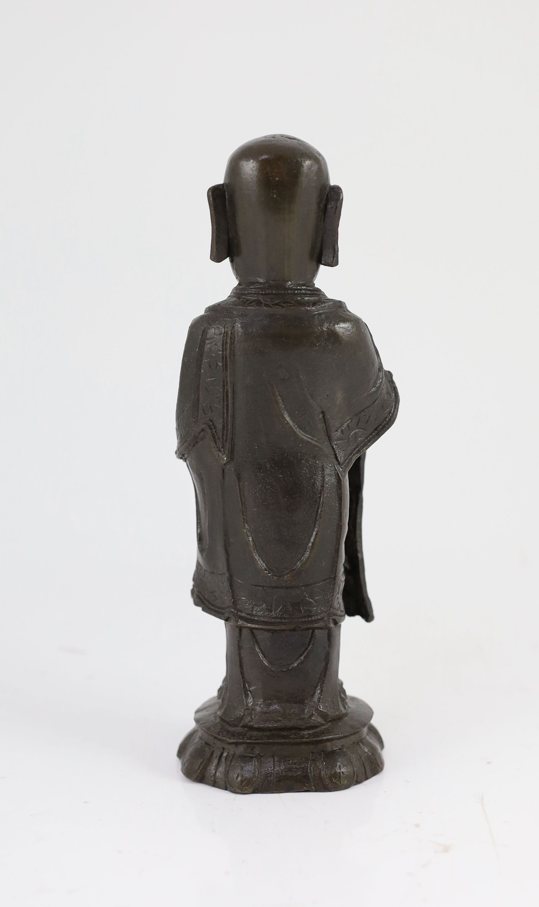 A Chinese Ming bronze figure of a luohan, 17th century, 21cm high